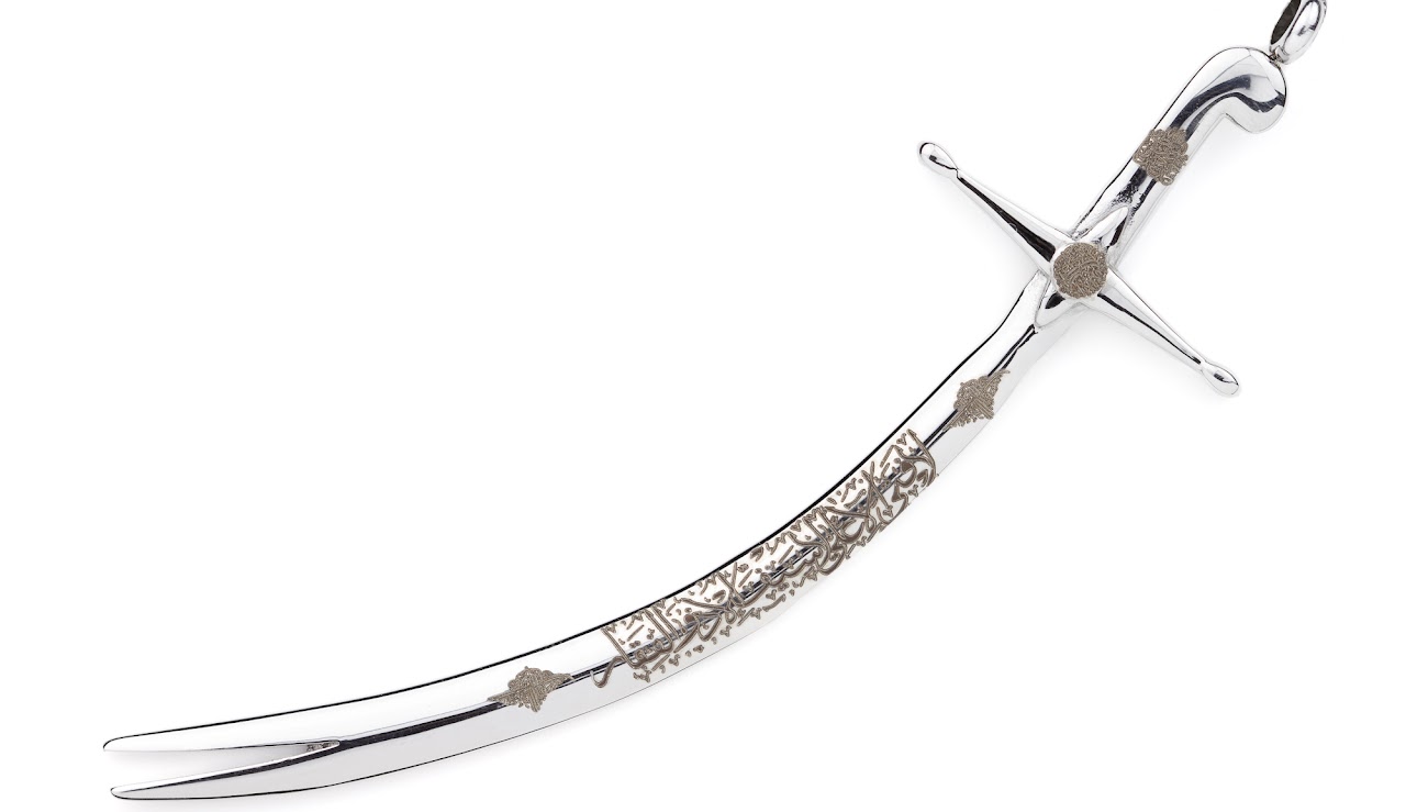 Close detail of the Arabic engraving on the Zulfiqar pendant